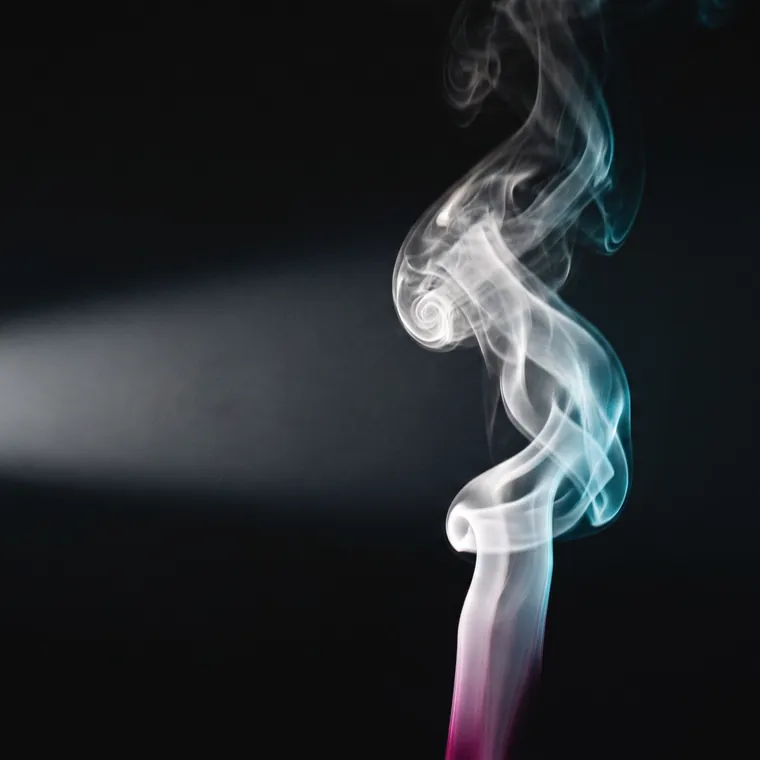 A single column of steam rising through a hard beam of light in an otherwise dark room, tinted cyan at its edge and magenta at its base.