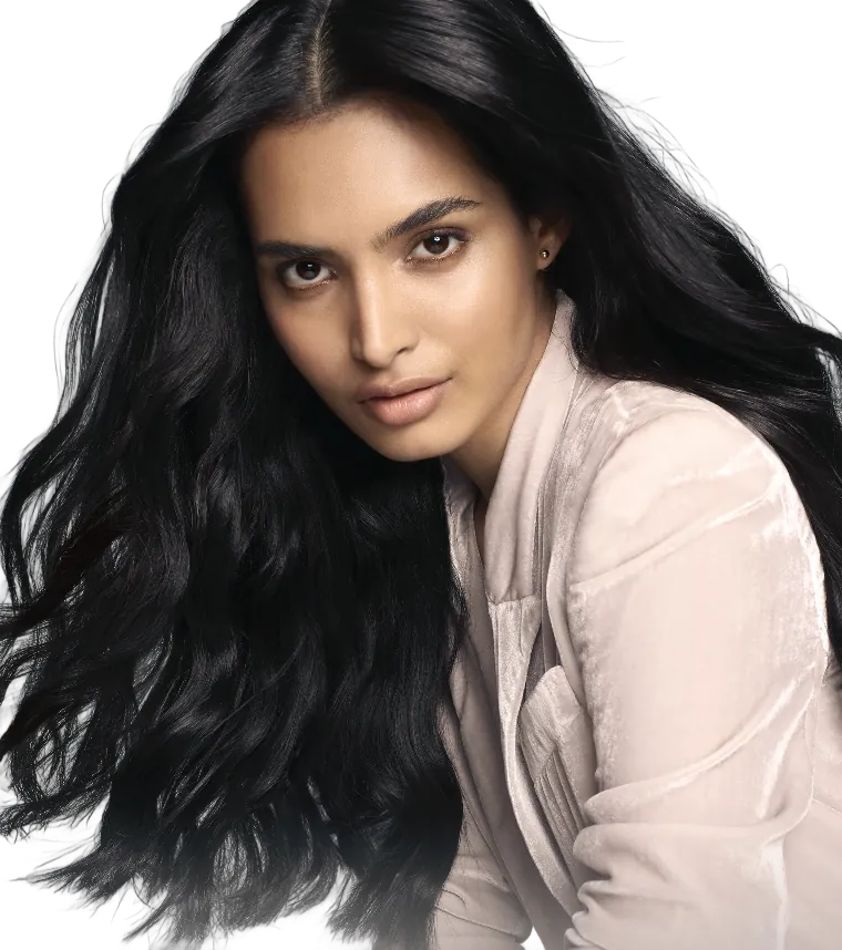 Long black hair swinging out mid-motion over a velvet blazer, cut out against the dark ground.